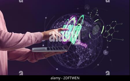 Man with laptop using software for data protection on dark background Stock Photo