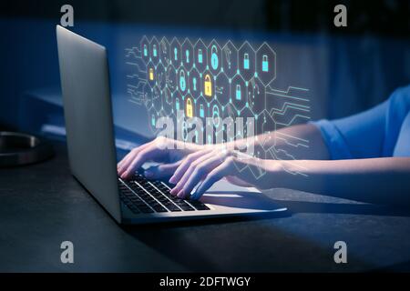 Woman with laptop using software for data protection on dark background Stock Photo