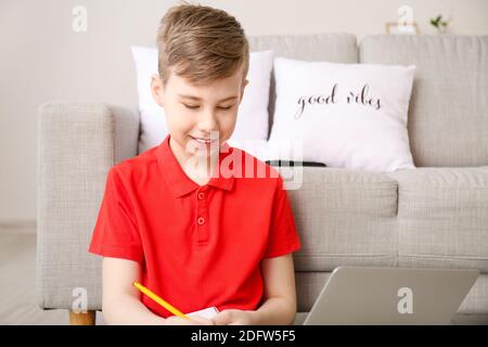 Cute boy doing homework at home Stock Photo