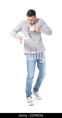 Stressed young man with coffee stains on his shirt on white background Stock Photo