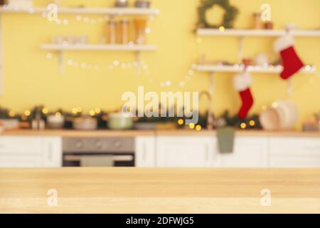 Empty wooden table in kitchen decorated for Christmas Stock Photo