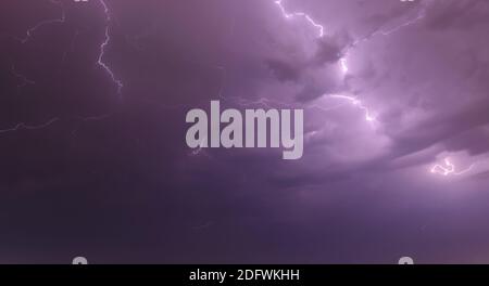 Stormy sky at night. Forked lightning spreading in the sky above Porto Alegre. Bad weather in the South of Brazil. Stock Photo