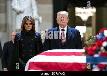 US President Donald J. Trump (R) and his wife, Melania (L), pay respects to former President George H.W. Bush as he lies in state in the Rotunda of the US Capitol in Washington, DC, USA, 03 December 2018. President Bush died at the age of 94 on 30 November 2018; he was the 41st President of the United States (1989âÂ€Â“1993). Stock Photo