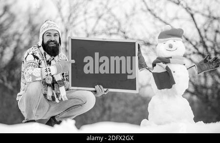 Giving our best. happy hipster with blackboard. winter season. Christmas  sales. winter holiday. Party here. man advertising board. Copy space.  bearded Stock Photo - Alamy