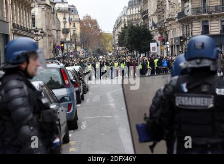 Police clash on Saturday december 8, 2018 in Paris, France, with protesters staging a fourth weekend of 'gilets jaunes,' or 'yellow vest,' demonstrations against the government of President Macron. Officers fired rubber bullets and hundreds of canisters of tear gas at the demonstrators, some of whom had set vehicles on fire. Interior Minister Christophe Castaner said 135 people were wounded in Saturday's protests across France, including 17 police officers. Castaner said 1,385 people were taken in for questioning and 974 were in custody. Two photographers from the newspaper Le Parisien were hi Stock Photo