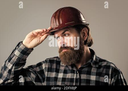 it will be perfect. brutal builder in helmet. bearded repairman. confident construction engineer. professional architect. repair and building. responsible for safety. serious male worker in hard hat. Stock Photo