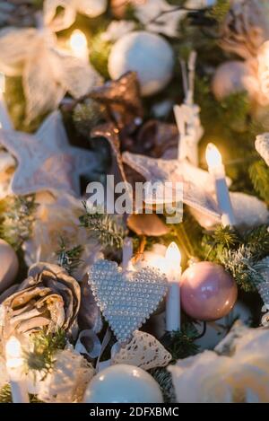 Christmas ornaments are decorations usually made of glass, metal, wood or ceramics that used to festoon a tree. Blurred gifts on background. Stock Photo