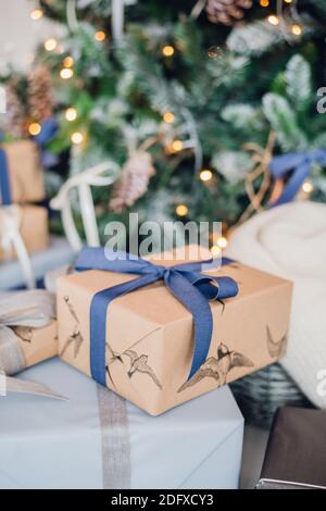 Christmas gift or present box wrapped in kraft paper on christmas decoration Stock Photo