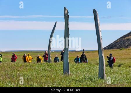 Tourists watching Bowhead Whale jawbones and ribs in arch formation, Yttygran Island, Bering Sea, Russian Far East Stock Photo