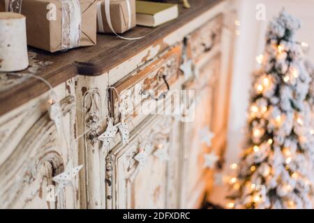 Christmas star and other decoration on ancient commode. Happy new year conception Stock Photo
