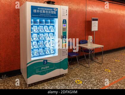 December 7, 2020, Hong Kong, Hong Kong SAR, China: Hong Kong, China:07 Dec, 2020. Vending machines are set up at 10 MTR (Mass Transit Railway stations for public to collect COVID-19 specimen collection packs with convenience.As a 4th wave of Covid-19 cases engulfs Hong Kong, the MTR corporation new vending machine in North Point Station proves very popular. 10,000 jars will be distributed each day with packs supplied by a government contractor.Once used, members of the public can drop the jars at Hospital Authority Out-patience Clinics or 13 Department of Health clinics.Jayne Russell/ZUMA P Stock Photo