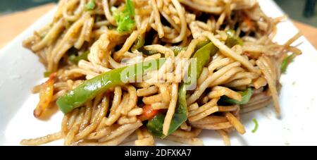 Closup of schezwan Noodles or vegetable Hakka a popular Indo-Chinese recipe Stock Photo