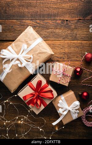 Christmas presents hand craft wrap paper on wooden background. Top view Stock Photo