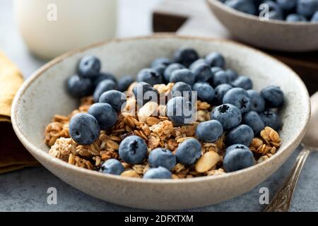Breakfast granola with blueberries in bowl. Closeup view. Healthy food, dieting concept Stock Photo