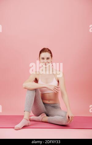 Woman resting on yoga mat Stock Photo