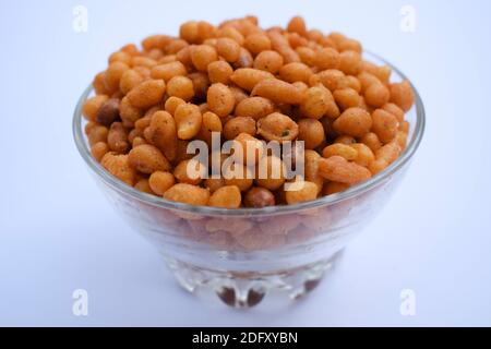 Indian famous namkeer snack Kara boondi or spicy salty boondi served in transparent bowl. Tea time snack fried chickpea floour or besan deep fried in Stock Photo