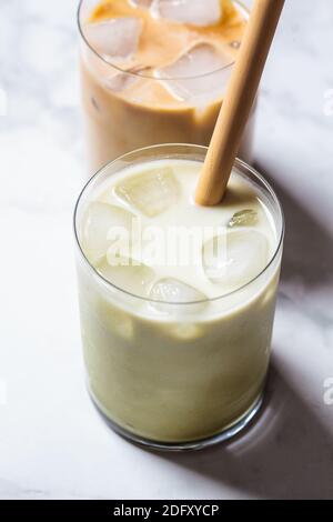 Cold summer drinks concept. Ice latte matcha and ice coffee in glass glasses, white background. Stock Photo