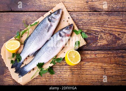fresh fish sea bass on wooden table Stock Photo