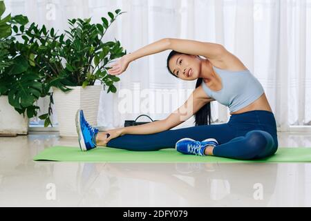Woman doing side bends Stock Photo