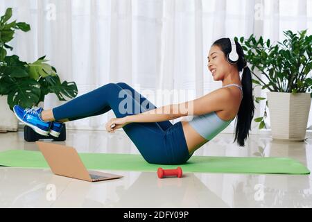 Woman doing abs exercise Stock Photo