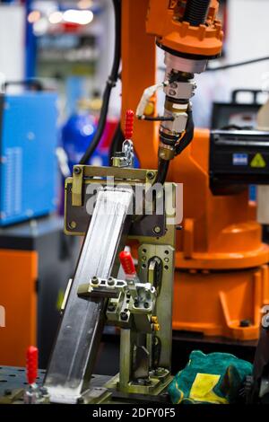 Industrial robot arm welding structural beam in construction heavy industry. Stock Photo