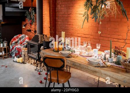 Stylish home interior with festively decorated dining table. The concept of interior design during the New Year holidays Stock Photo