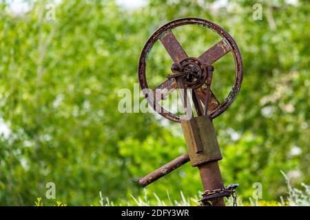 Fragment of old machine. Rusty wheel for belt in unknown mechanism. Steampunk style Stock Photo