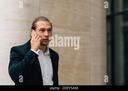 Young businessman talking on mobile phone Stock Photo