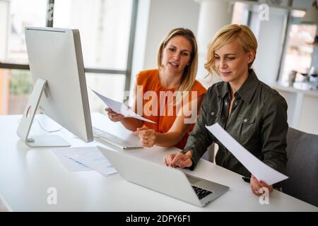 Business women working at the office on computer Stock Photo