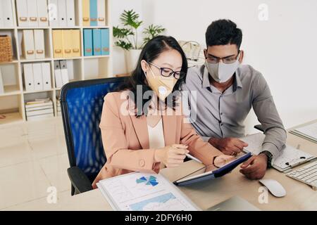 Business meeting in protective masks Stock Photo