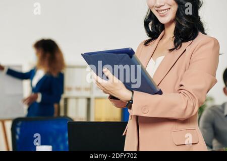 Businesswoman reading contract on tablet Stock Photo