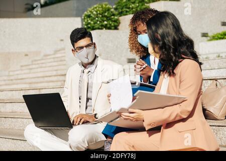Entrepreneurs having meeting outdoors Stock Photo