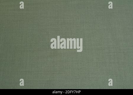 Textured background made of dark green wool fabric. Stock Photo