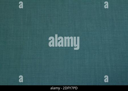 The background is textured denim dark green color for the autumn and winter wardrobe. Stock Photo