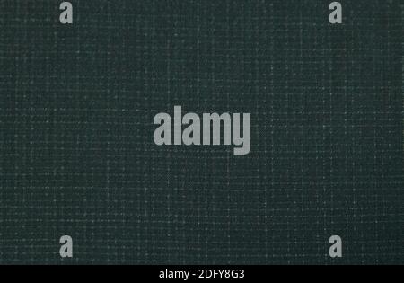 Background of dark textured purple wool fabric in a small cage for sewing autumn and winter clothing. Stock Photo