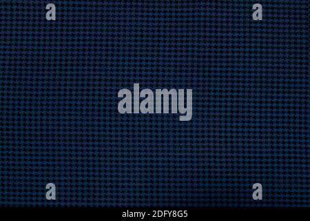 A close-up of the background made of blue-black wool textured fabric is suitable for autumn and winter wardrobe. Stock Photo