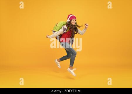 Finally graduated. child being late. sense of freedom. childhood activity. little girl listen music in headphones. back to school. small schoolgirl running to school. hurry up its holiday time. Stock Photo