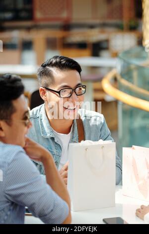 Man meeting with friends in cafe Stock Photo