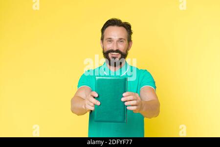 Literary critic. Man mature bearded guy hold book. Satisfied reader. Book presentation concept. Author presenting book copy space. Bestseller and book store. Literature taste and recommendations. Stock Photo