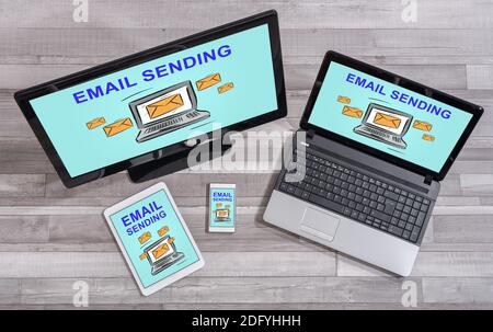 Email sending concept shown on different information technology devices Stock Photo