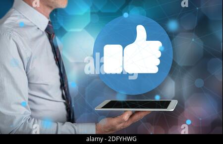 Rating concept above a tablet held by a man Stock Photo