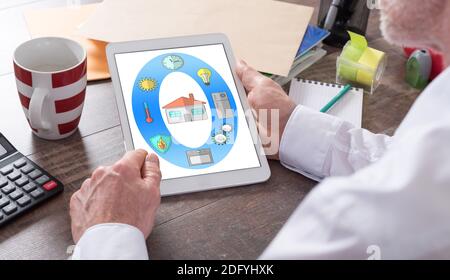 Smart home concept shown on a tablet held by a man Stock Photo