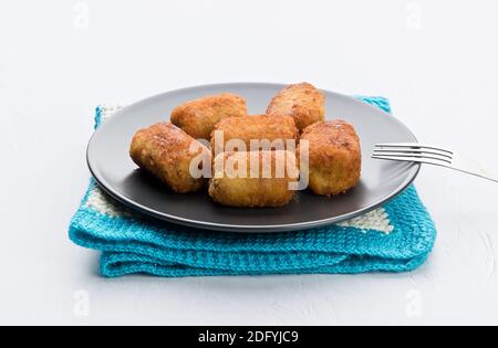 The croquette is a portion of dough made with a mince of various ingredients, which together with bechamel is coated in egg and breadcrumbs, and final Stock Photo