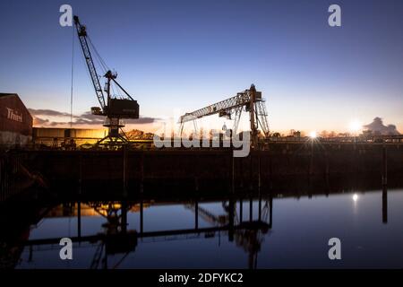 loading cranes in the Rhine harbor in the district Deutz, Cologne, Germany. Stock Photo