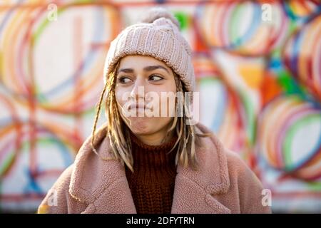 Playful young woman with braided hair outdoors Stock Photo