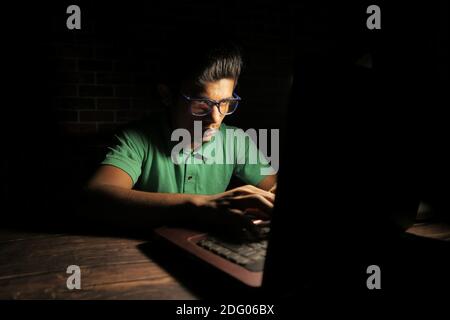 young man working on laptop stealing personal data  Stock Photo