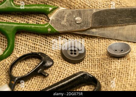 Old vintage sewing accessories. Needle with threads. Scissors. Centimeter.  Thimble Stock Photo - Alamy