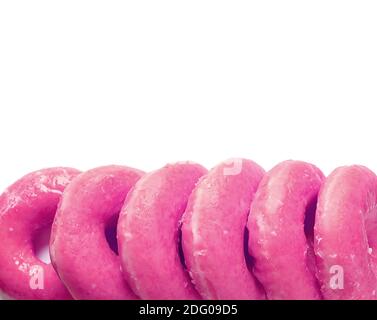Row of mouthwatering vibrant pink strawberry-glazed doughnuts isolated on white background Stock Photo
