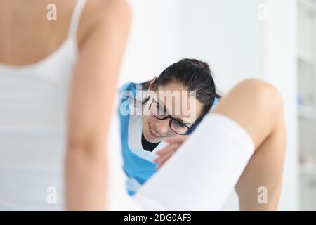 Professional gynecologist examines patient in clinic using professional equipment. Stock Photo