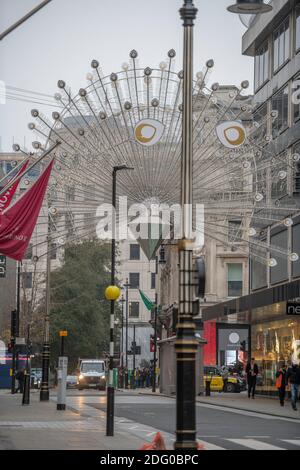 London, UK. 7 December 2020. Christmas lights above a quiet New Bond Street in central London with a temperature a few degrees above freezing. Credit: Malcolm Park/Alamy Live News. Stock Photo